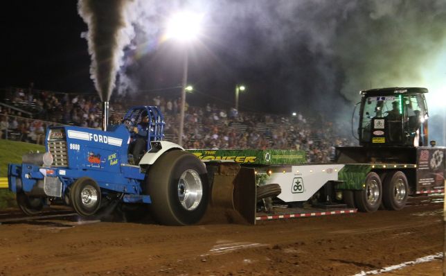 Ford tractor pulling Pioneer Seed Sled